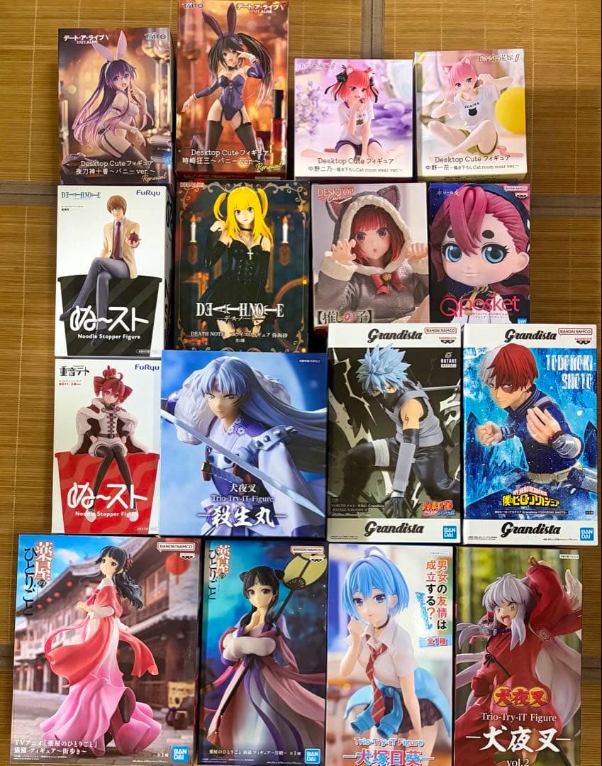 A grid of boxed anime prize figure packages arranged on a mat showing the front artwork and packaging.