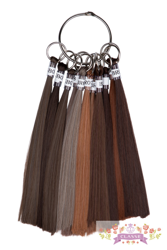 A metal ring holding multiple synthetic wig hair color swatches in various brown shades.