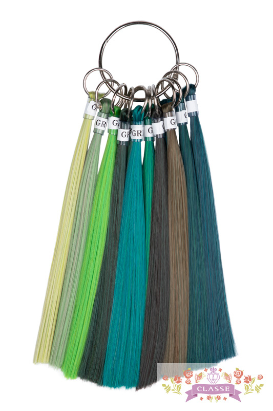 Green hair color sample swatches on a metal ring showing synthetic wig color options.