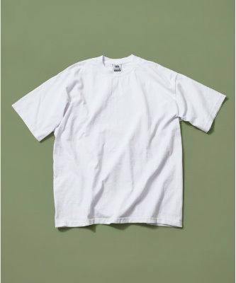 White heavyweight short-sleeve crew neck T-shirt laid flat on a green background.