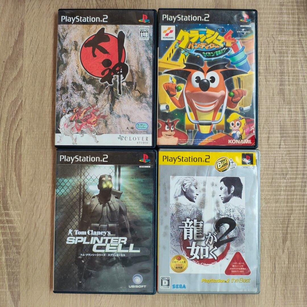 Four PlayStation 2 game cases (Okami, Crash Bandicoot 4, Tom Clancy's Splinter Cell, Yakuza 2) arranged in a 2-by-2 grid on a wooden surface.