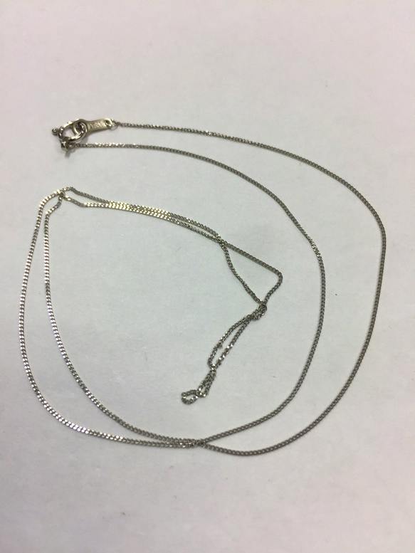 Pt850 platinum 50cm necklace laid flat on a white background showing the chain and clasp.