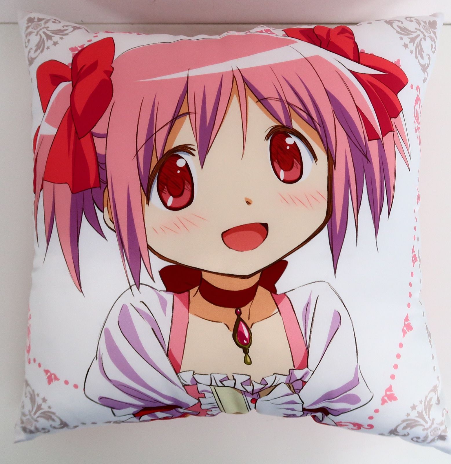 Front view of a square cushion printed with the anime character Madoka Kaname from Puella Magi Madoka Magica.