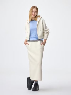 Model wearing the women's narrow sweatshirt skirt shown full-length with hands in pockets.