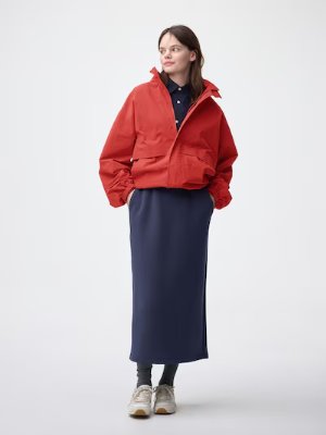 Model wearing the women's narrow skirt shown full-length with a jacket and sneakers.