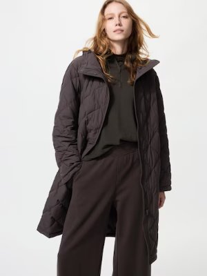 A model wearing the women's nylon long coat in a relaxed fit, shown standing with the front open.