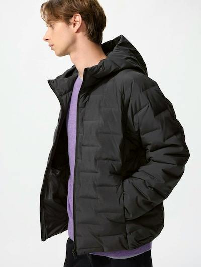 Men's black puffer parka jacket (polyester) worn by a model in a side view with hood and a partially open zipper.
