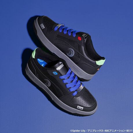 Pair of Puma Rebound Slam Lo Zero Recoil sneakers in black with blue laces shown on a blue background.