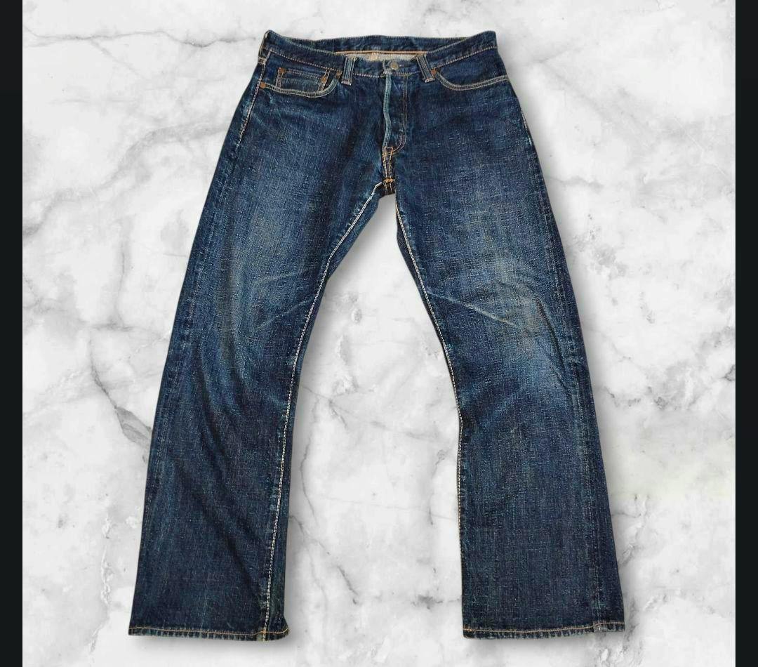 Front view of Pure Blue Japan straight denim jeans laid flat on a marble background.