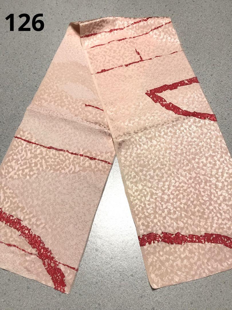Pink silk kimono fabric (half-collar sized) with red decorative lines laid flat and labeled "126".