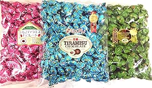 Three large clear bags of individually wrapped Purere tiramisu chocolates in pink, blue, and green wrappers arranged side by side.