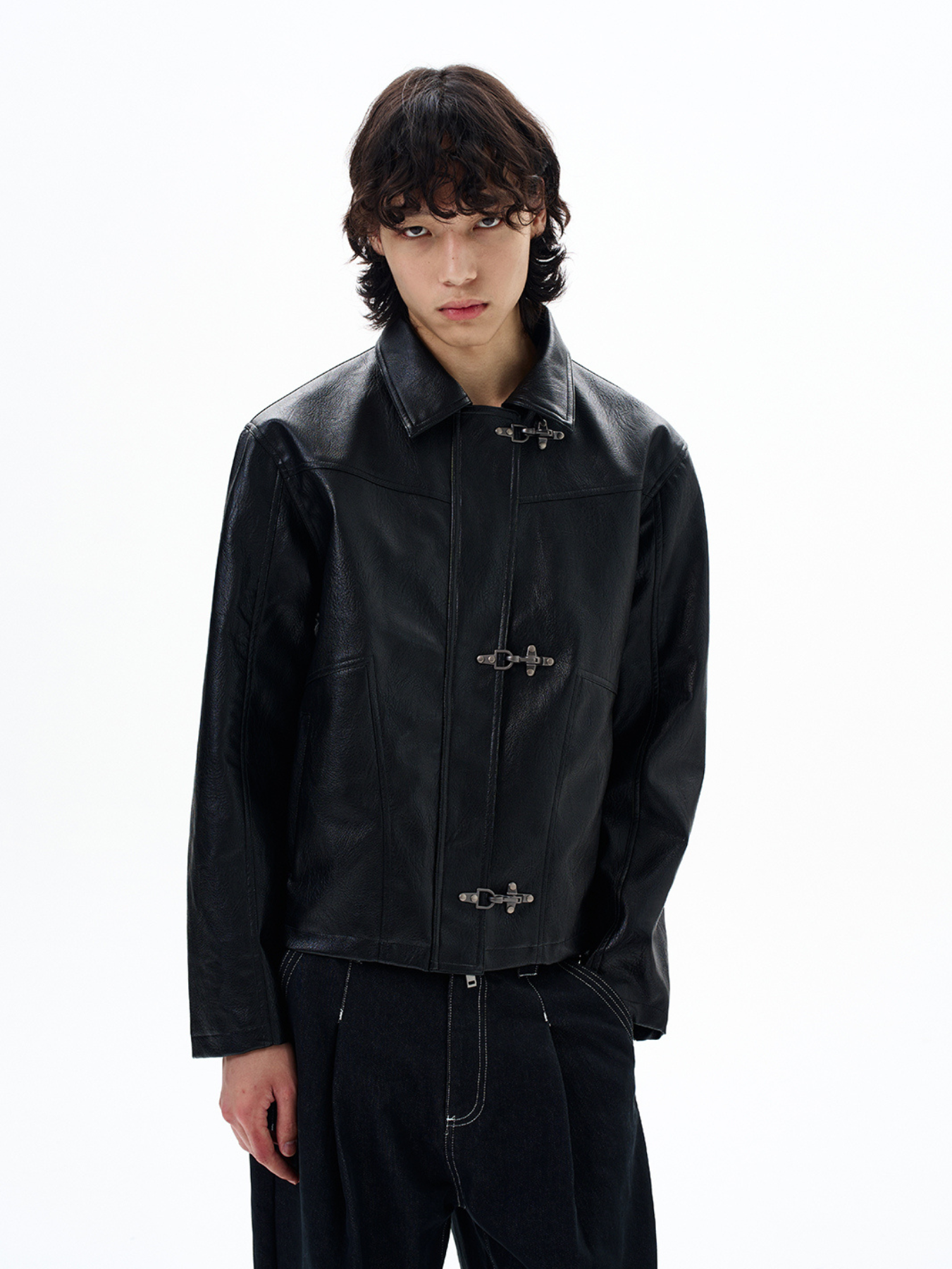 Male model wearing QS650B men's synthetic leather jacket in black against a white background.