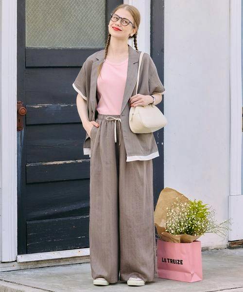 Woman wearing wide-leg linen-blend pants as part of a matching set, standing outdoors.