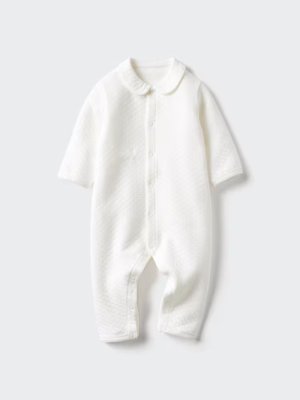 Child's white quilted long-sleeve coverall pajama with a rounded collar laid flat.