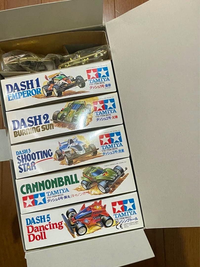 Opened memorial box showing five Tamiya Racing Mini 4WD Vol.1 model kit boxes neatly stacked inside.