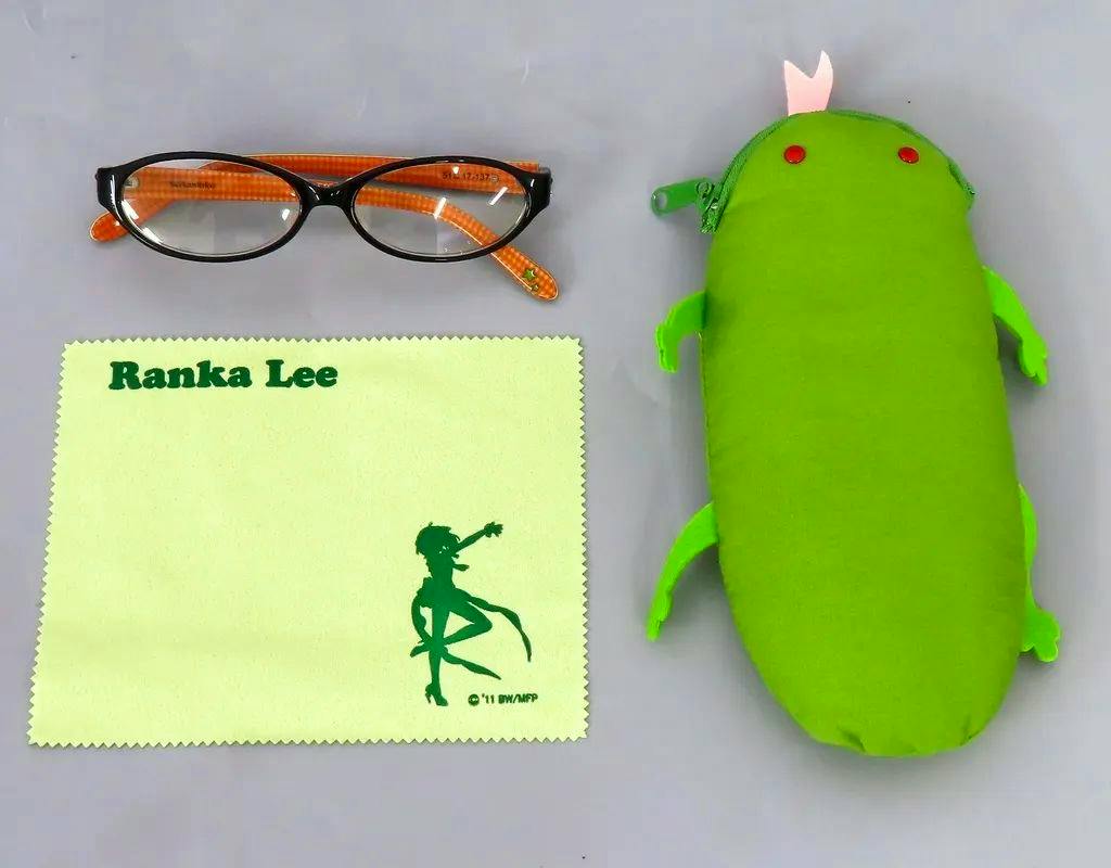 Pair of corrective glasses with black fronts and orange temples shown with a Ranka Lee cleaning cloth and a green plush case.