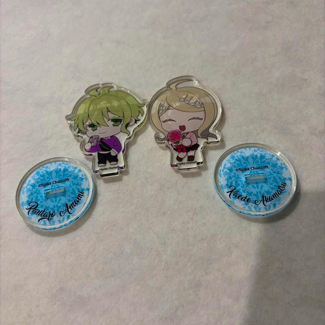 Front view of two Danganronpa acrylic standees with their two circular bases arranged on a light surface.