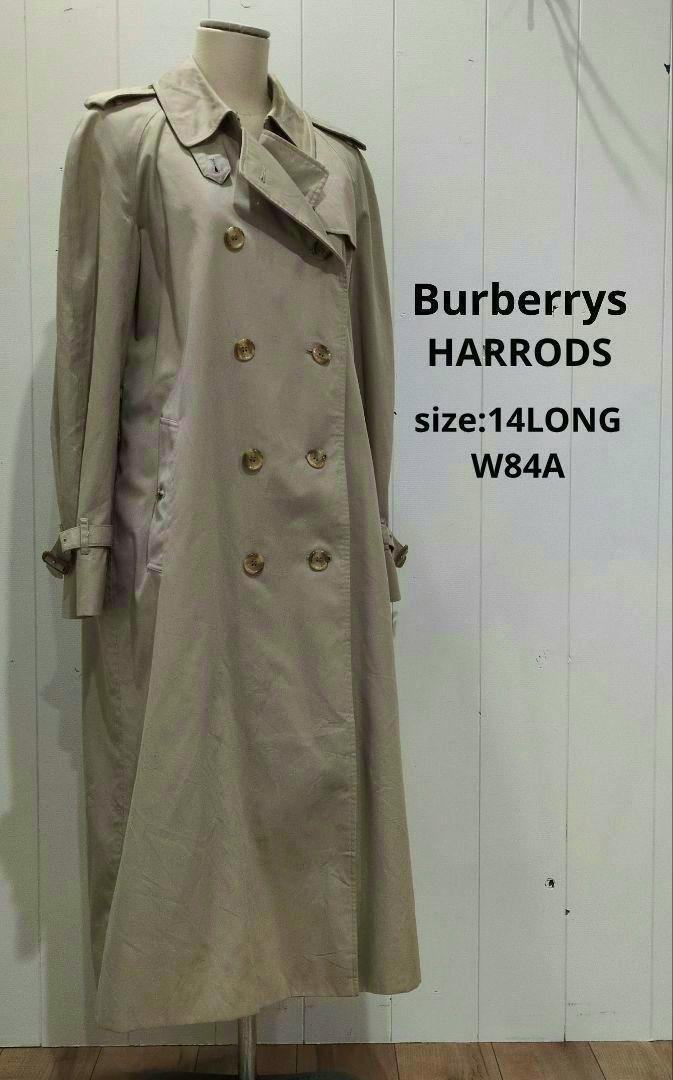 Long beige Burberrys trench coat displayed on a mannequin with size text on the background.
