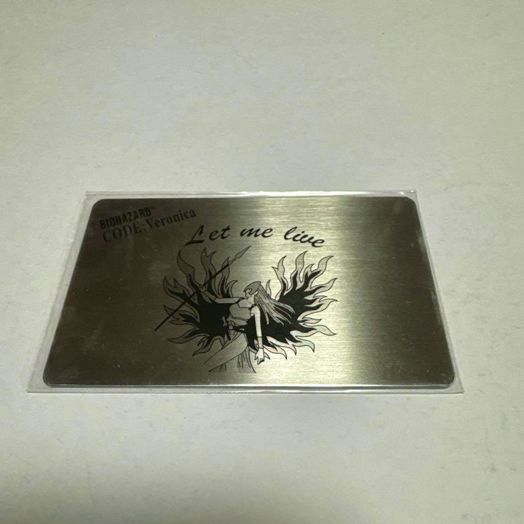 Metal plate for Biohazard (Code: Veronica) showing printed character artwork and the text "Let me live".