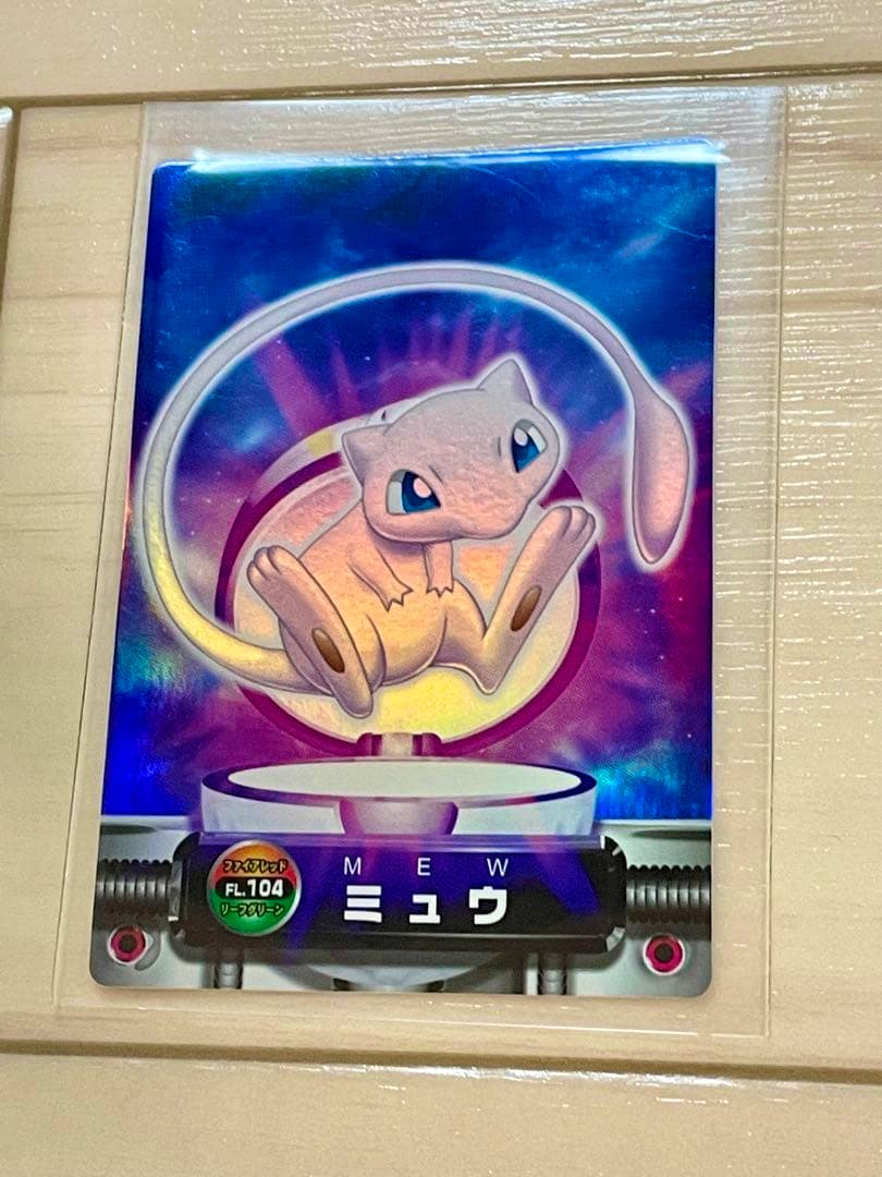 Front holographic image of a Pokémon Carddass Mew trading card showing Mew artwork and Japanese text.