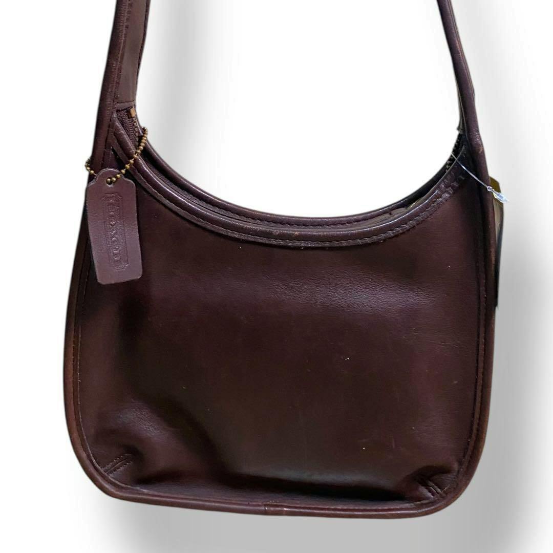 Brown cow-leather Coach shoulder bag shown on a plain white background.