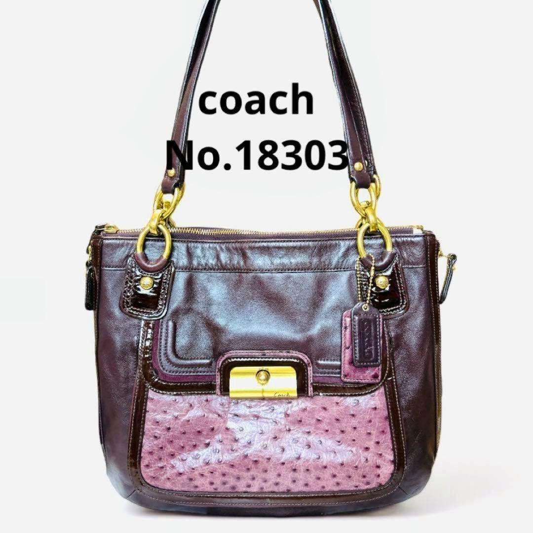 Front view of the vintage Coach Kristin spectator handbag in dark brown leather with a pink textured front pocket, gold hardware, top handles, and a Coach hang tag.