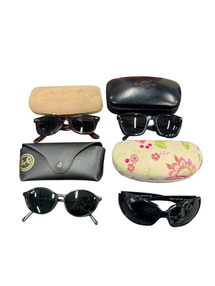 Four pairs of plastic sunglasses with their cases arranged on a white background.