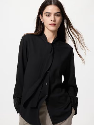 Model wearing a black rayon bow-tie blouse.