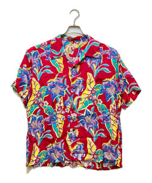 Front view of a men's rayon short-sleeve Aloha shirt with a red background and blue and yellow floral print hanging on a hanger.