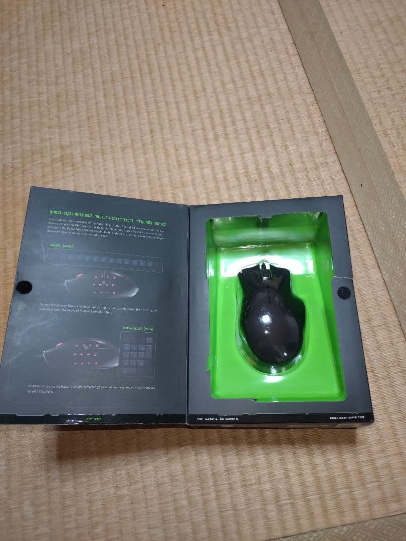 Photo of the Razer Naga Molten Special Edition PC mouse visible inside its opened packaging tray.