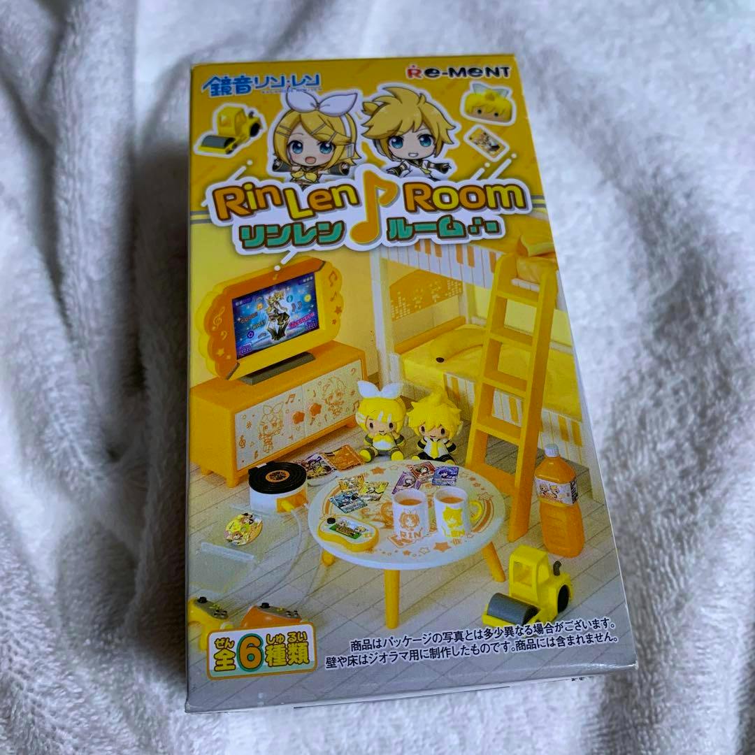 Photograph of the boxed Re-Ment "Rin Len Room" miniature figure set showing the room diorama artwork on the package placed on a white blanket.