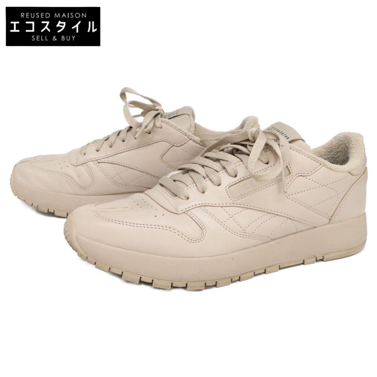 Pair of off-white Reebok x Maison Margiela Classic Leather Tabi sneakers on a white background.