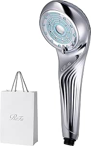 Silver ReFa Fine Bubble U shower head displayed next to a shopper bag.