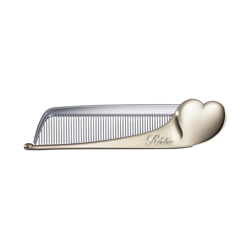 A gold-colored plastic hair comb with a heart-shaped handle on a white background.