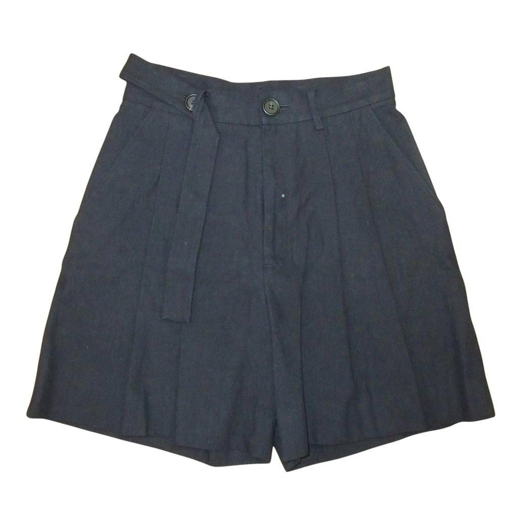 Flat-lay black women's pleated tuck shorts with belt detail on a white background.
