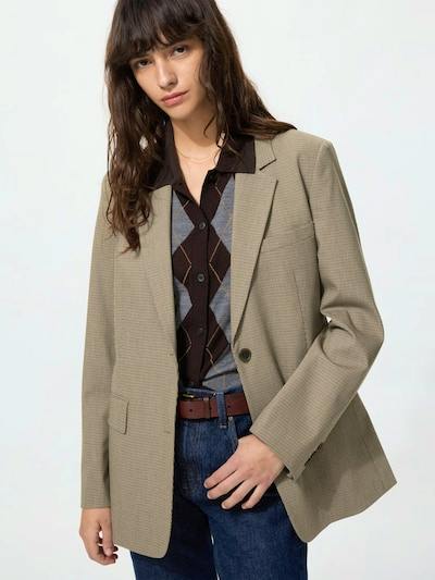 Model wearing the checked relaxed-fit tailored men's jacket, shown from mid-torso with the jacket front, lapel, and pockets visible.