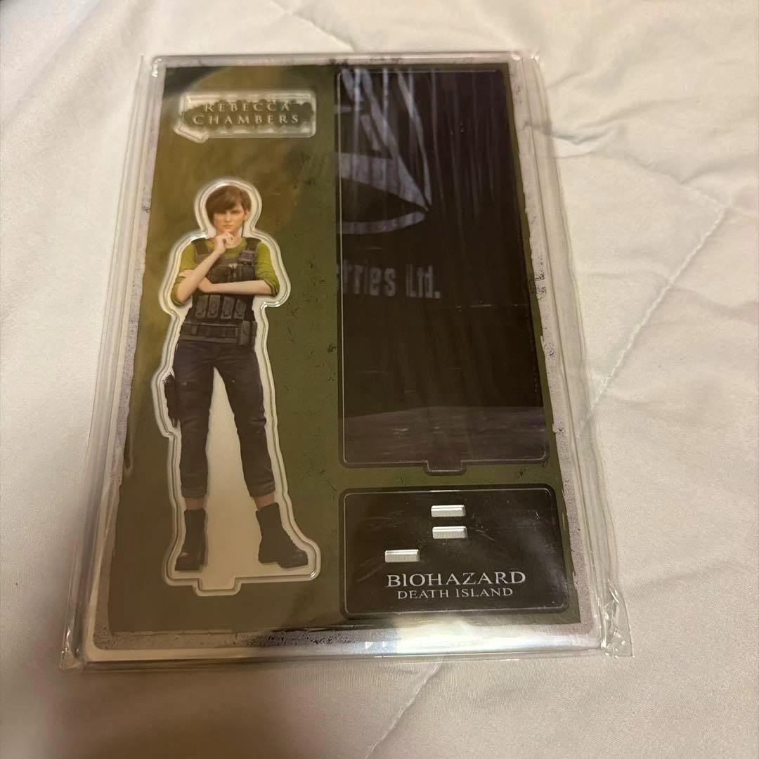 Packaged Biohazard: Death Island acrylic stand showing the Rebecca character piece and its display base.