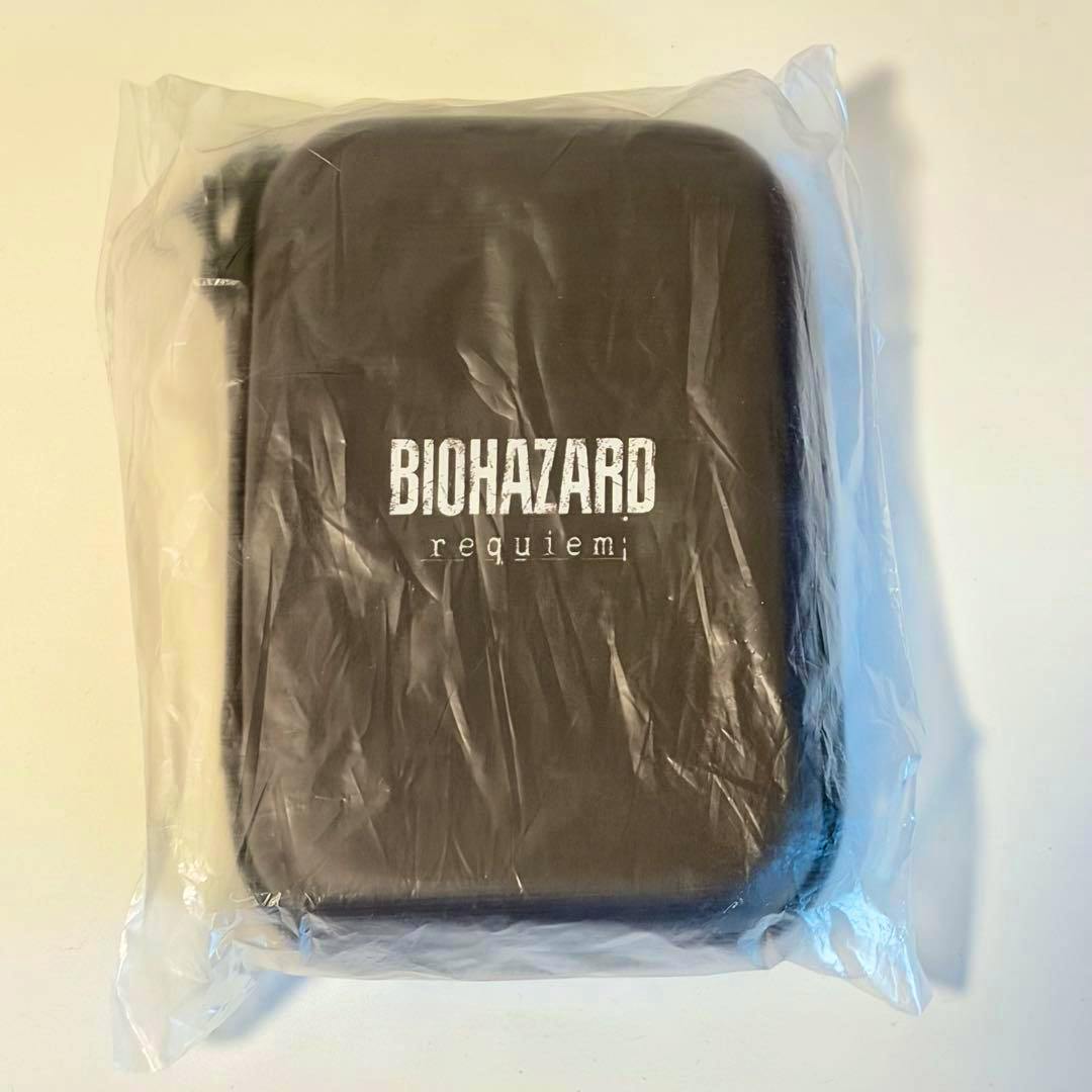 A black Biohazard Requiem gadget pouch in clear plastic packaging showing the white "BIOHAZARD requiem" logo on the front.