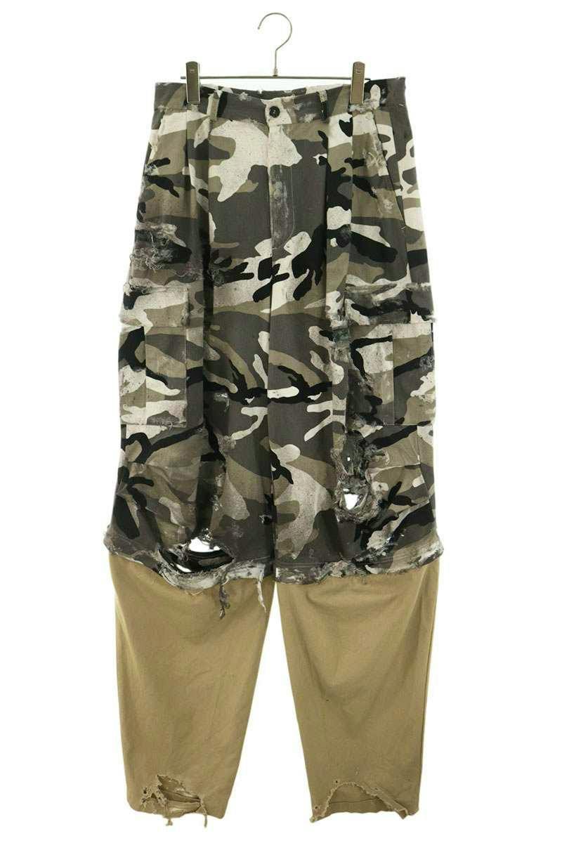 Front view of the men's cotton docked cargo long pants with a camouflage upper section and khaki lower legs hanging on a hanger.
