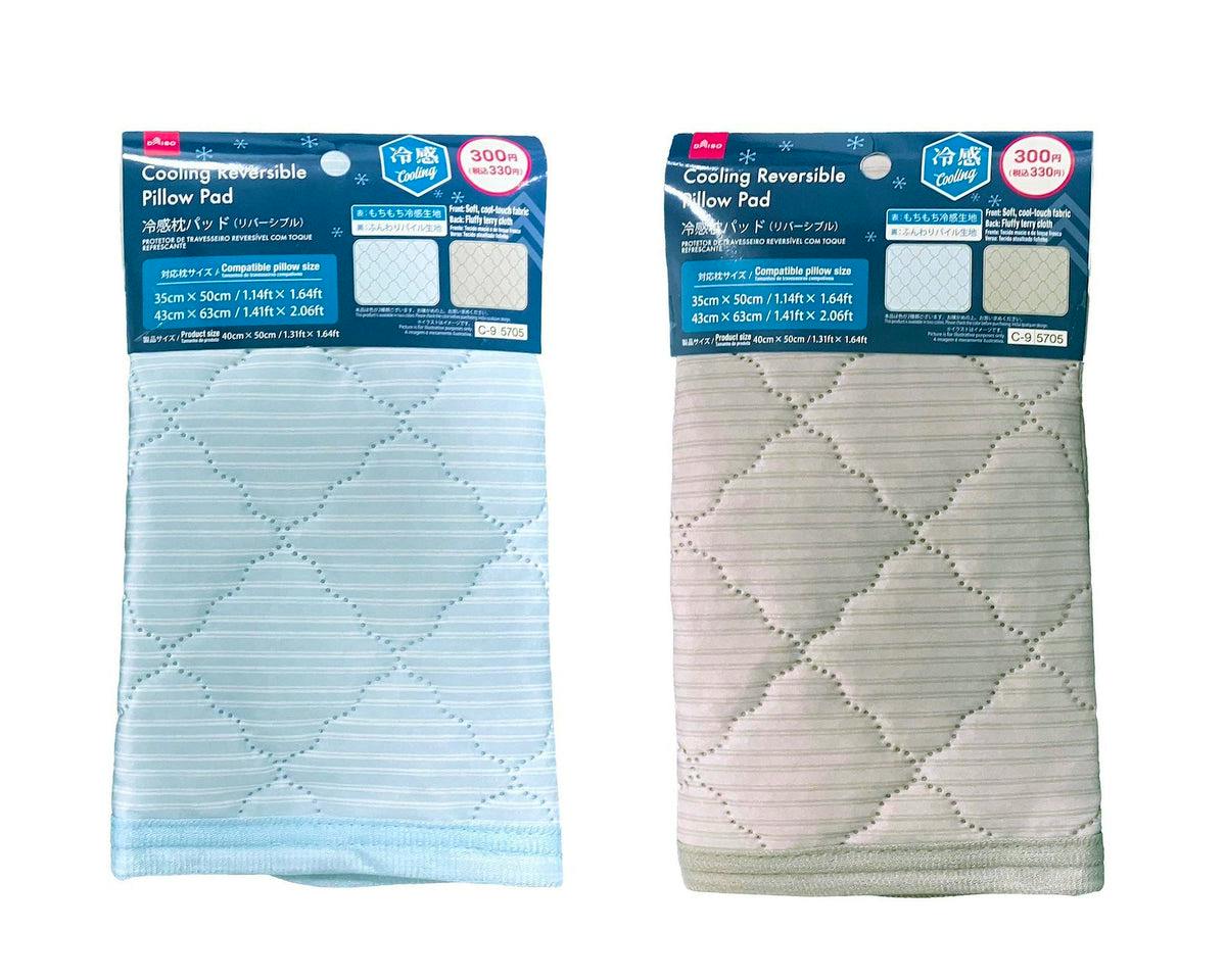 Two packaged cooling reversible pillow pads in light blue and beige with header cards.