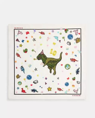 Square white cotton bandana with a central cartoon dinosaur wearing a party hat and scattered small colorful icons.