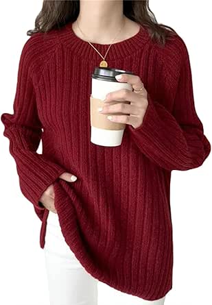 Person wearing a red ribbed long-sleeve crew-neck sweater holding a takeaway coffee cup.