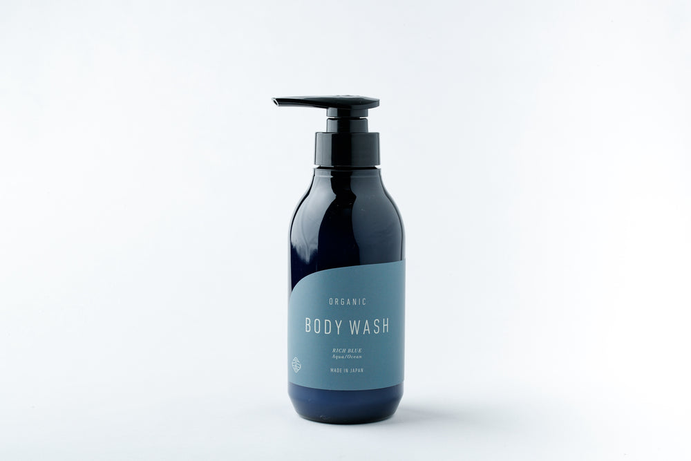 A blue pump bottle of body wash with a pale blue label on a white background.