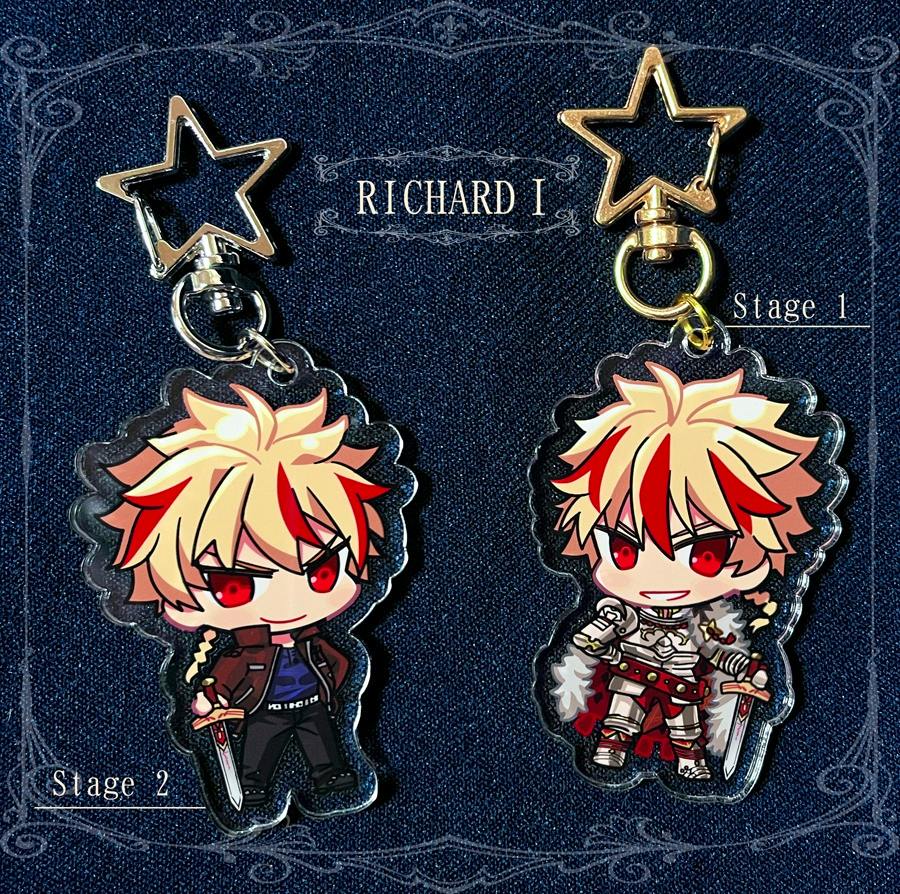 Two acrylic keychains showing the chibi Richard character in two stages, each with a star-shaped clasp on a dark fabric background.