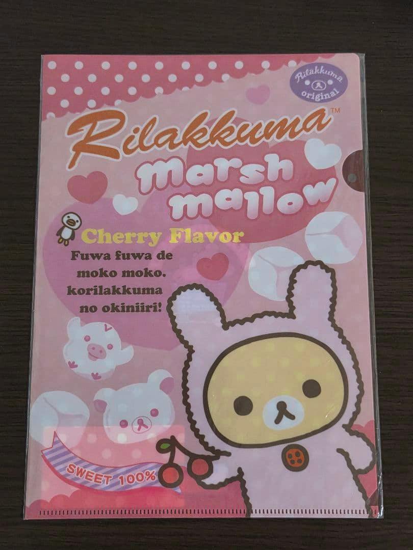 Front view of the Rilakkuma clear file showing a pink marshmallow-themed design with cherries and hearts.