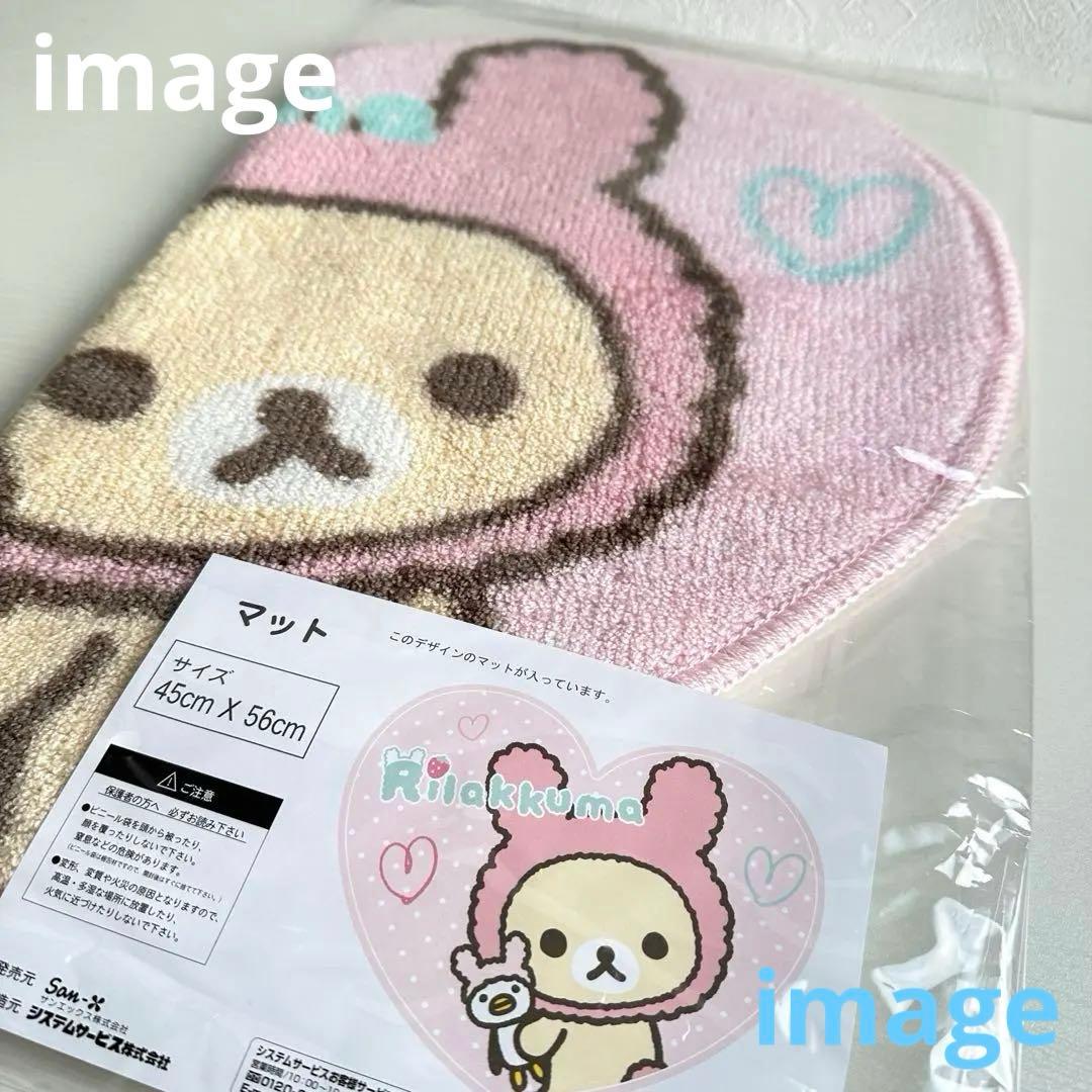 Pink heart-shaped Korilakkuma floor mat with a rabbit-hood design and a visible size label (45cm × 56cm).