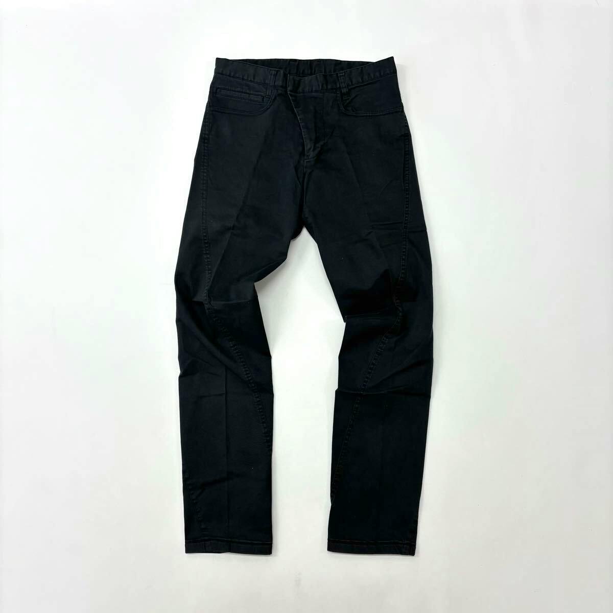 Front view of black stretch pants laid flat on a white background.