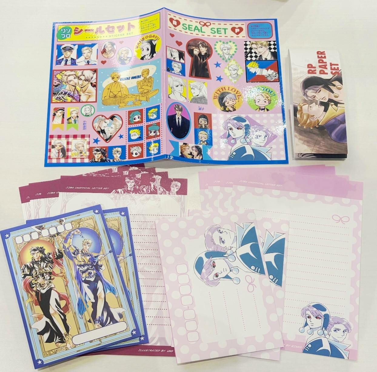 A flat lay of the letter set showing an open sticker sheet, several illustrated writing papers, and a folded RP PAPER SET booklet.