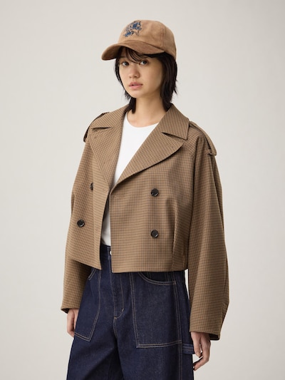 Model wearing the women's short trench check coat in a brown checked pattern.