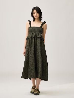 Model wearing the women's smocking dress by rokh shown full-length.